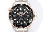 Omega watch front view with black dial, rose-gold bezel markers, and stainless-steel bracelet