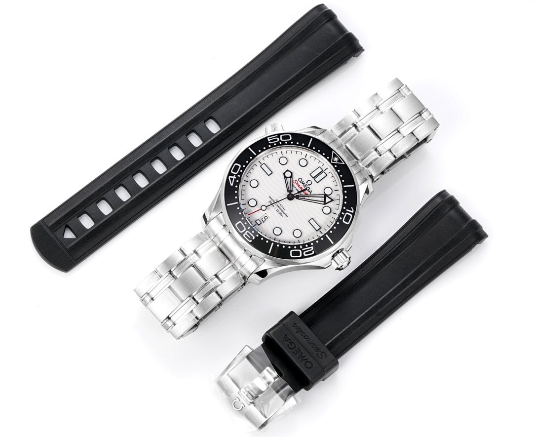 Omega watch shown with stainless steel bracelet and black rubber strap pair.