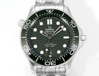 Stainless steel diver watch with green dial, date window, and metal bracelet