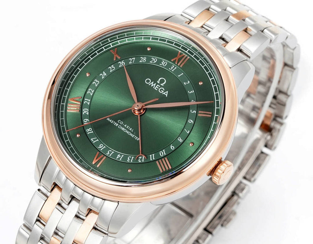 Two-tone wristwatch with green dial, gold hands, and stainless steel bracelet