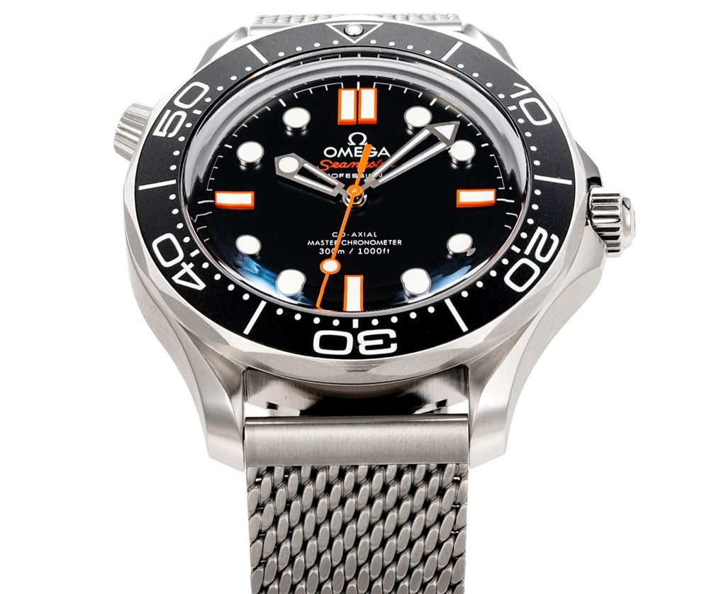 Wristwatch front view with black dial, orange markers, and stainless mesh band
