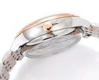 Watch caseback detail with rose-gold crown head and polished silver metal