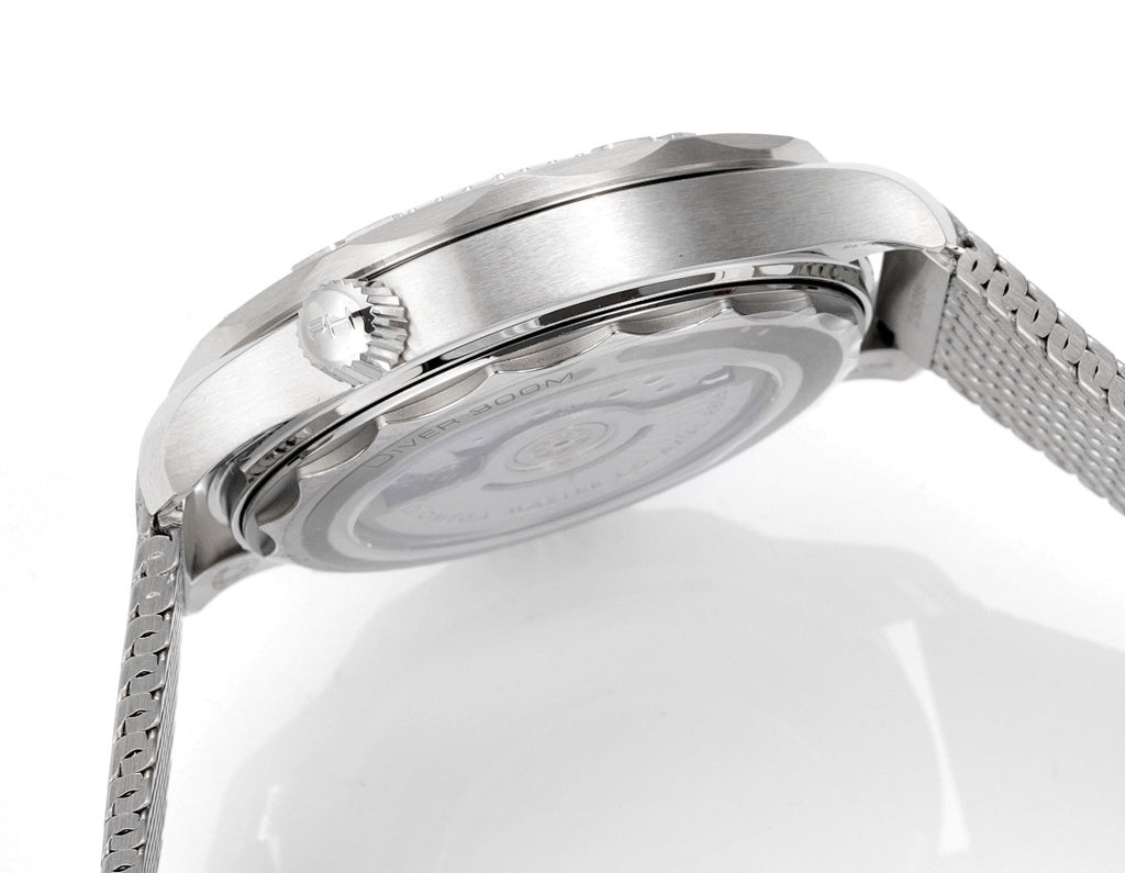Stainless steel watch caseback with gray mesh bracelet and crown, close-up angle.