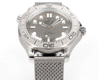 Stainless steel diver watch with textured bezel and gray mesh bracelet, front view.