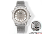 Stainless steel diver watch with gray mesh bracelet and silver dial, three-hand design.