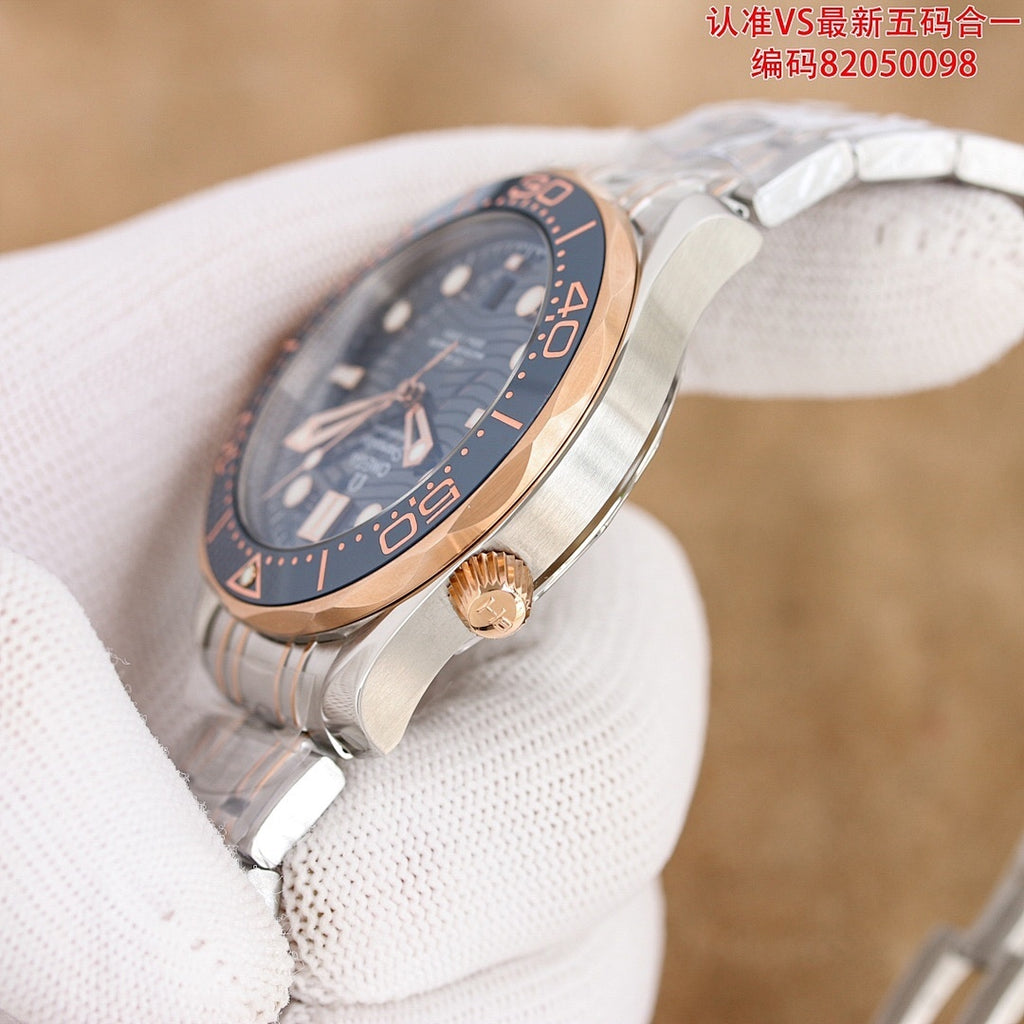 Omega watch with dark blue dial and rose-gold case, crown detail on wrist