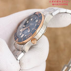Omega watch with dark blue dial and rose-gold case, crown detail on wrist