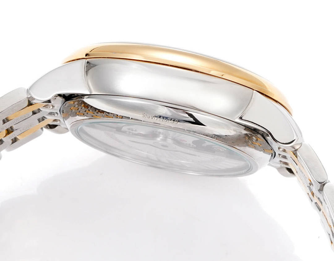 Omega watch rear case view with gold trim and clear back window on metal bracelet