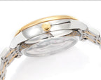 Omega watch side with gold crown and clear case back on two-tone metal bracelet