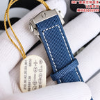 Omega Speedmaster watch close-up with blue strap and metal buckle on white cushion