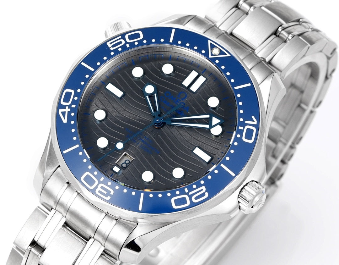 Omega stainless dive watch face with blue bezel, dark dial, and metal bracelet