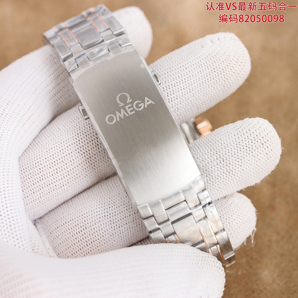 Omega watch clasp with engraved Omega logo on stainless steel bracelet.