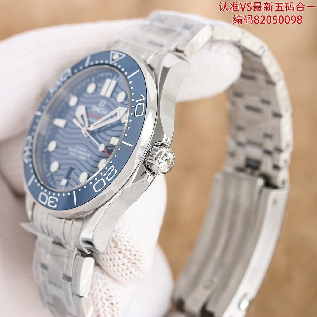 Omega watch angled view with dark blue dial, blue bezel, and stainless steel bracelet.