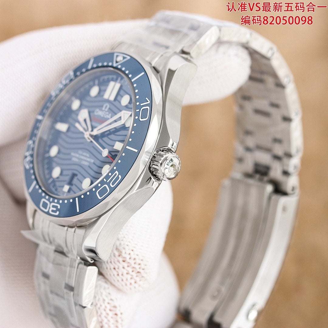 Omega watch angled view with dark blue dial, blue bezel, and stainless steel bracelet.