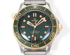 Omega watch with green dial, gold-tone bezel markers, metal mesh bracelet