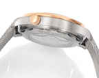 Omega watch caseback underside, brushed metal case, crown and mesh strap visible