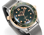 Omega watch angled view with green dial, gold-tone indices and hands, metal mesh strap