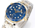 Omega dive watch close-up with blue dial and gold bezel markers, two-tone bracelet