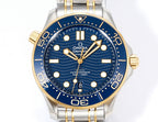 Omega dive watch front view with blue dial, gold bezel, two-tone metal bracelet
