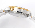 Omega watch case profile with gold bezel ring, blue bezel insert, and two-tone stainless bracelet