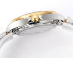 Omega watch case profile with gold crown, gold bezel ring, and two-tone stainless bracelet