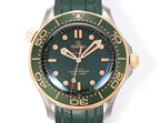 Omega watch front view with green dial, gold-tone bezel, and green rubber strap