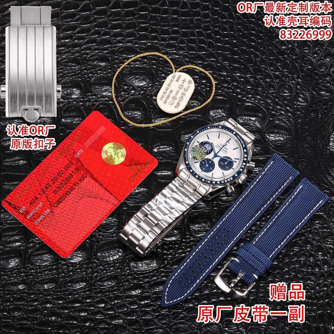 Stainless steel Omega chronograph watch with silver bracelet plus blue leather strap accessory.