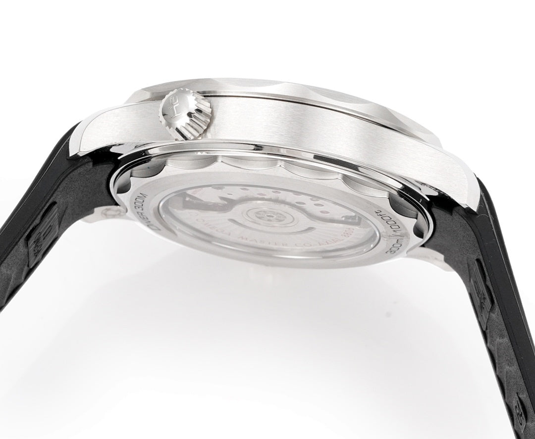 Omega watch underside close-up with silver caseback and black rubber strap.