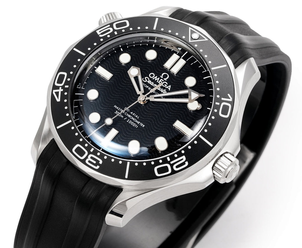 Omega watch face close-up with black dial, silver bezel, and black rubber strap.