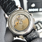 Omega Seamaster watch caseback showing gold-toned movement through transparent cover