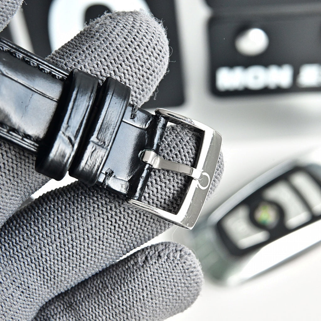 Black leather watch strap with metal buckle and clasp on grey fabric glove