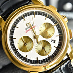 Omega Seamaster gold-tone chronograph wristwatch close-up, white dial with three subdials