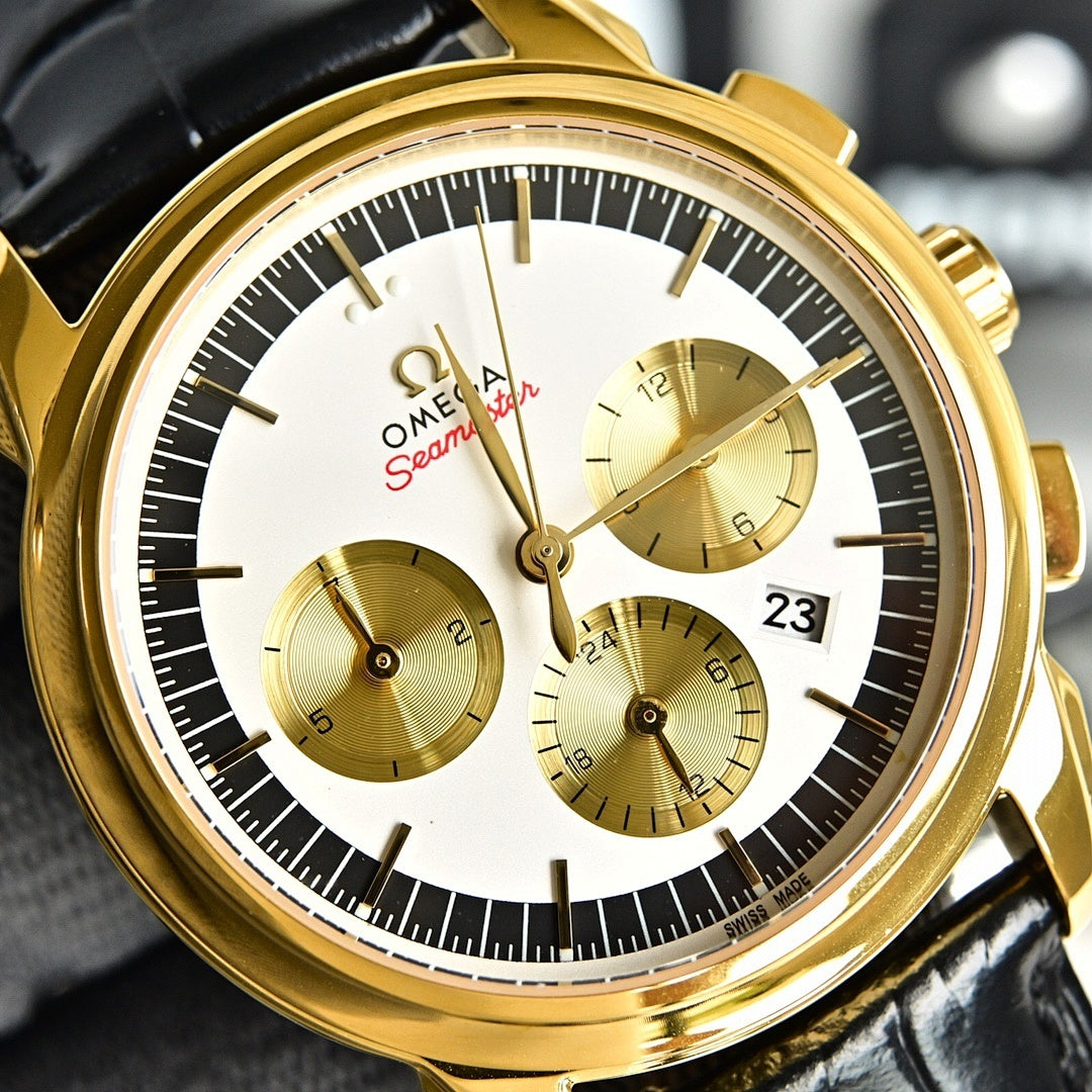 Omega Seamaster gold-tone chronograph wristwatch close-up, white dial with three subdials