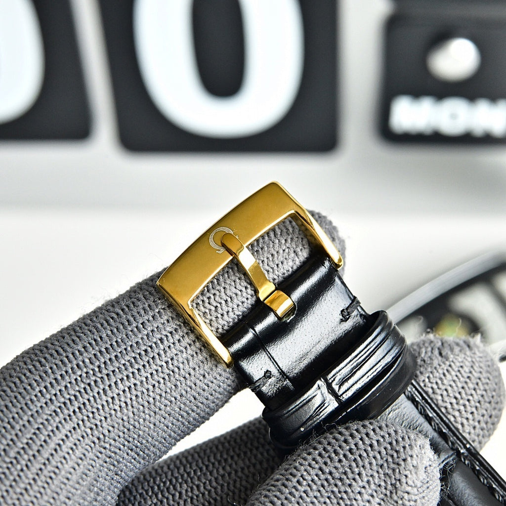 Omega Seamaster gold-tone watch buckle on black leather strap