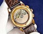 Omega watch caseback with visible mechanical movement and gold accents.