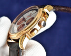 Omega watch side view with crown and gold-tone case on brown leather strap.