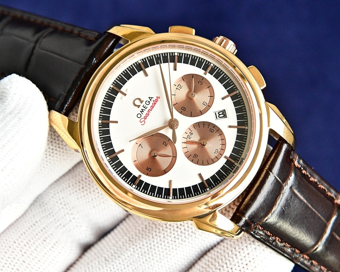 Omega Seamaster watch front view: gold case, white dial with brown subdials.