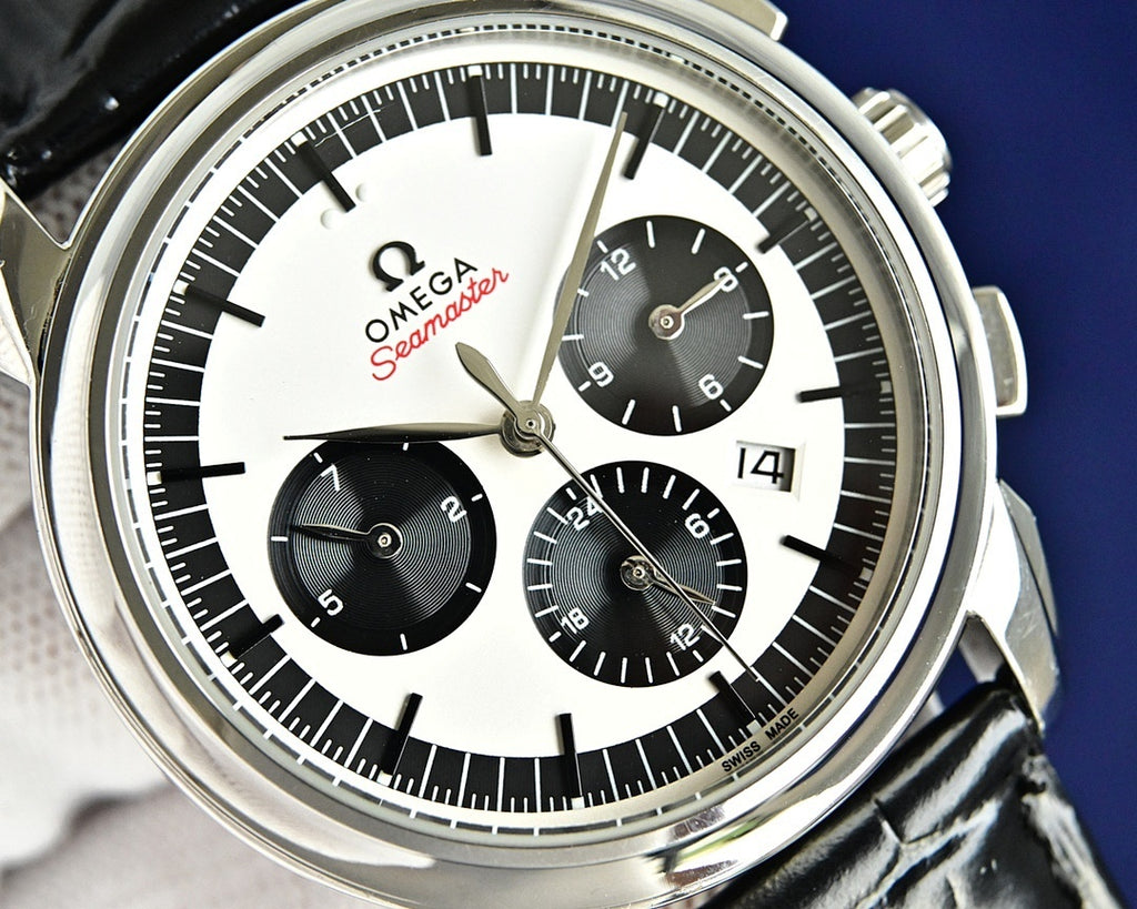 Omega Seamaster chronograph dial with black subdials, white center, and gold hands