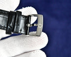 Omega Seamaster watch with black leather strap and silver buckle