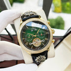 Omega watch with black leather strap, gold-tone bezel, green dial with skeleton hands and dials
