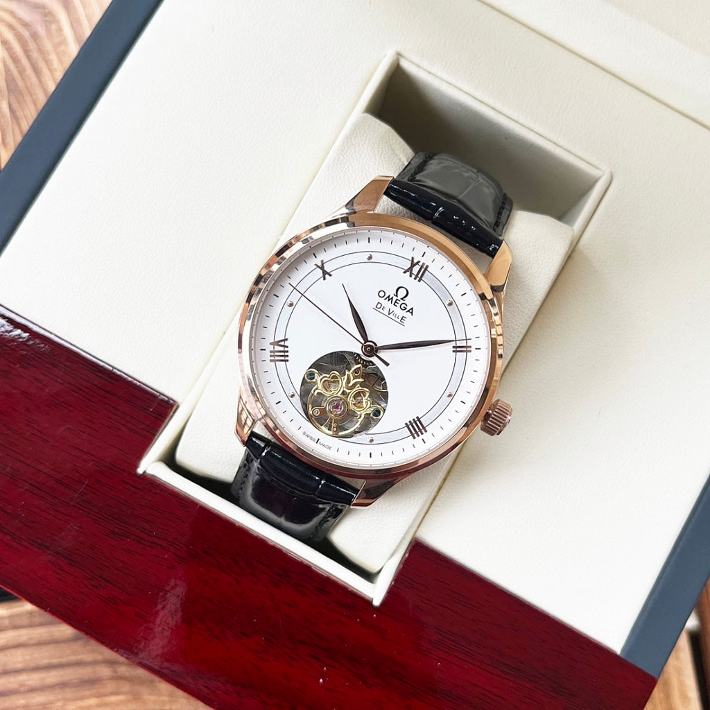 Omega De Ville wristwatch with rose-gold case, black leather strap, white dial.