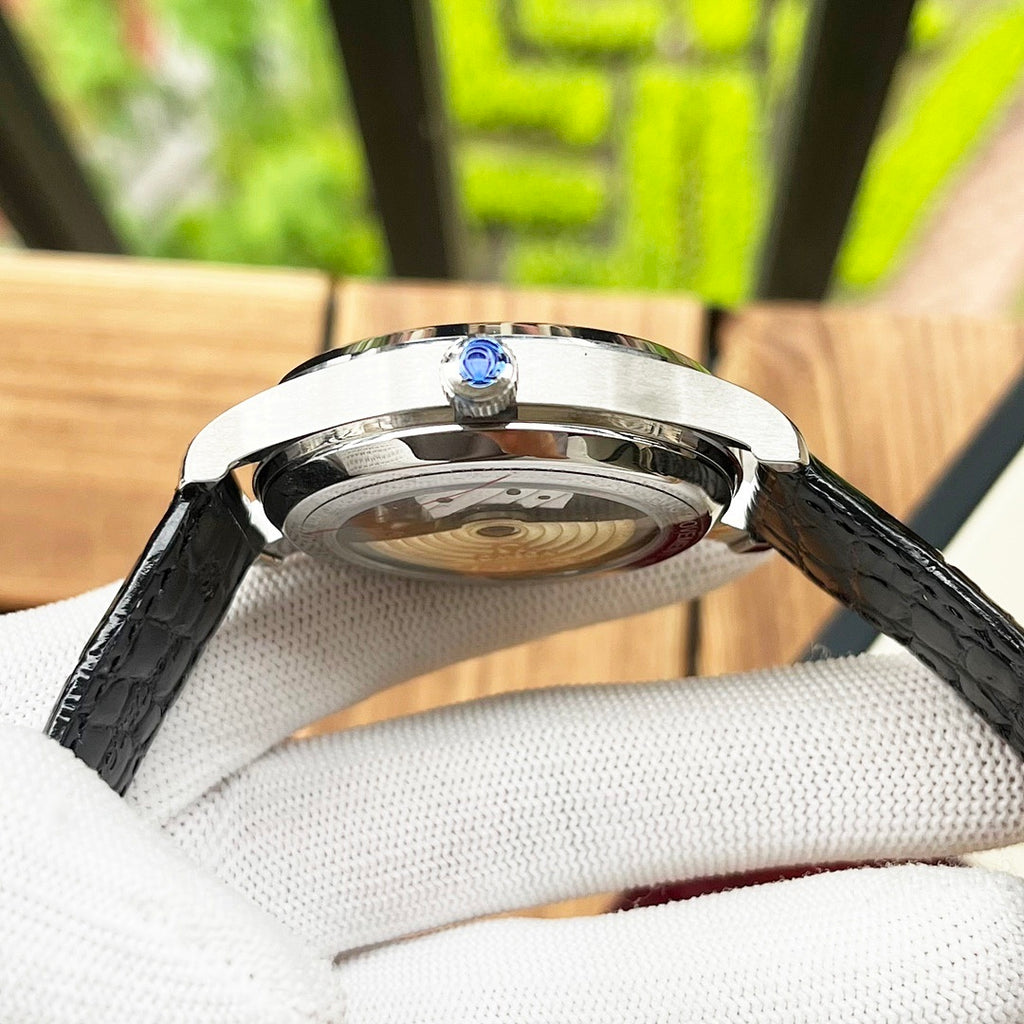 De Ville wristwatch side view with silver case and black leather strap
