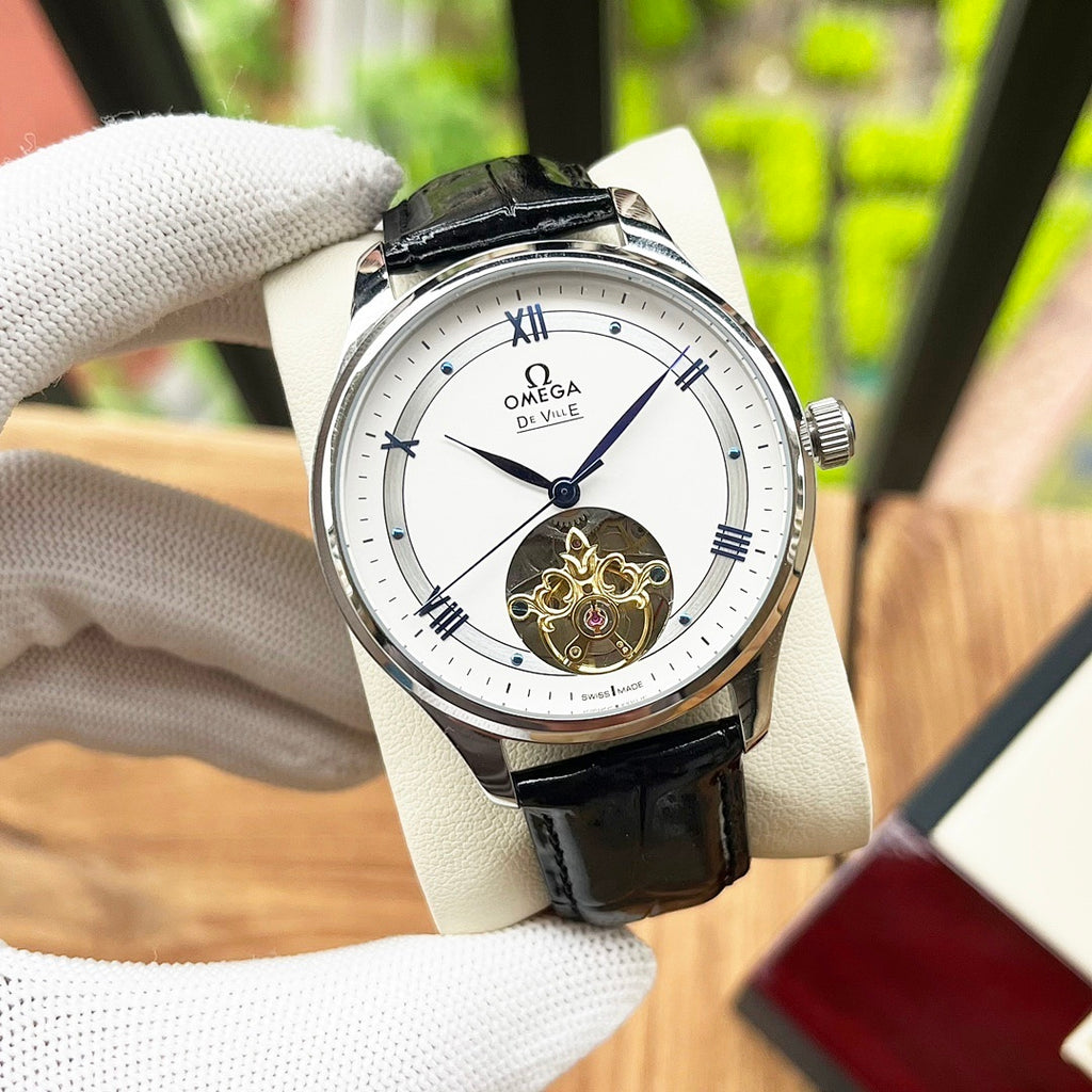 De Ville wristwatch with black leather strap and white dial, visible gold balance