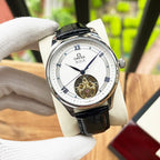 De Ville wristwatch with black leather strap and white dial, visible gold balance