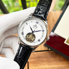 De Ville wristwatch close-up with black leather strap, white dial and silver case