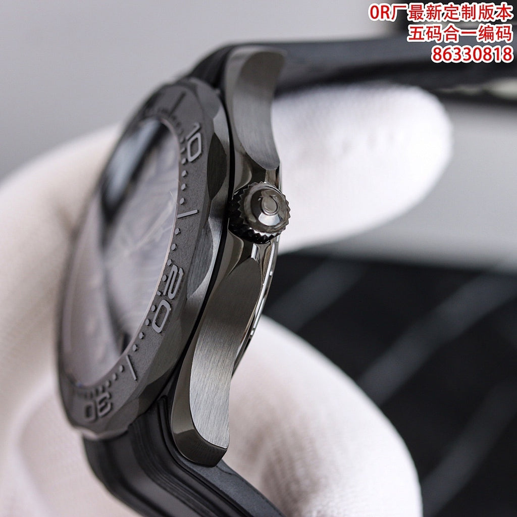 Diver watch side view with crown, black case edge, and textured rubber strap