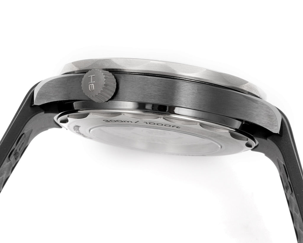 Black diver watch case and bezel close-up with brushed metal finish.