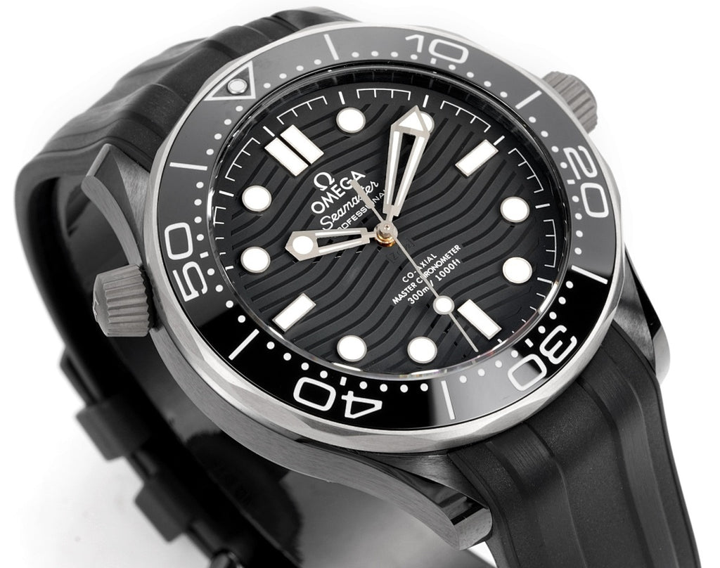 Black dial diver watch with silver bezel, white markers, and black rubber strap.