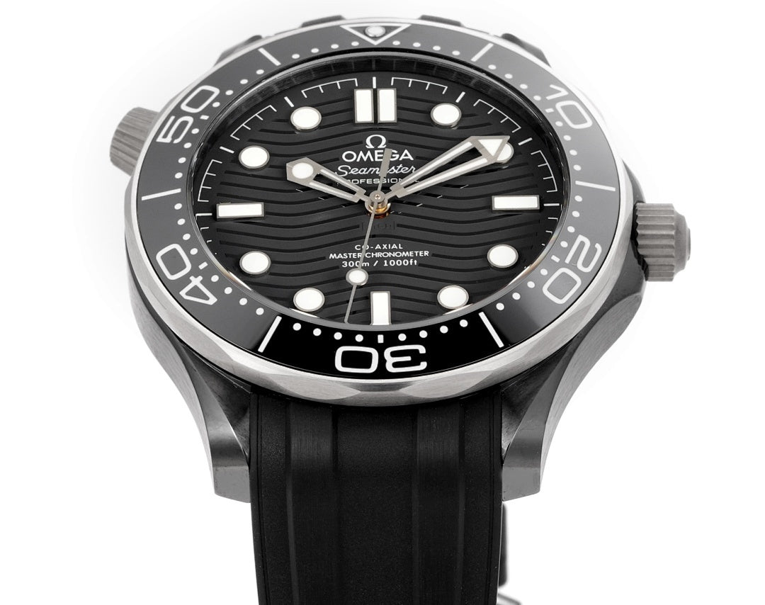 Black dial diver watch with silver bezel and black rubber strap, three-hand layout.