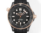 Front view of black rubber diver watch with rose-gold bezel, black dial, and gold-tone hands.